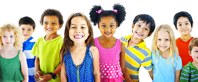 The image displays a group of children and adults, possibly a family or school class, posing for a photo with various expressions and attire.